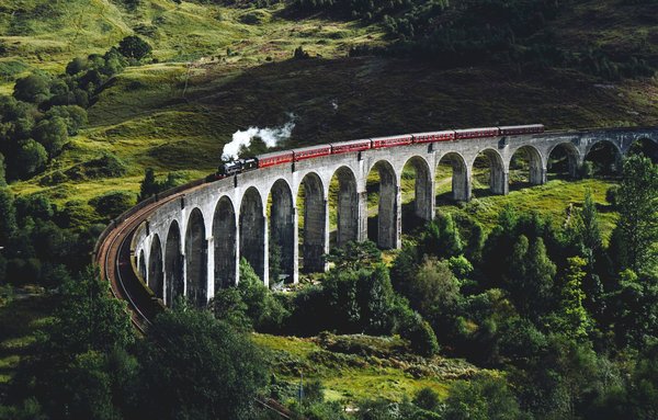 How can you plan a visit to the historic steam railway routes in Wales?